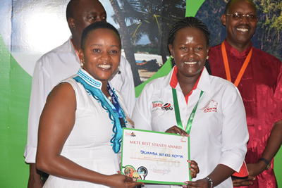 Excellent: Ms Ann Safari (left) the General Manager of Jacaranda Ocean Beach Resort receives an award for the best stand in hotels category. About 40 hotels participated in the expo.